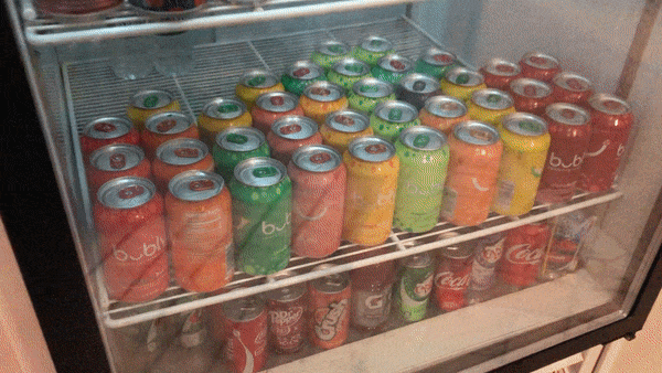 grabbing a bubly sparkling water from the drink fridge