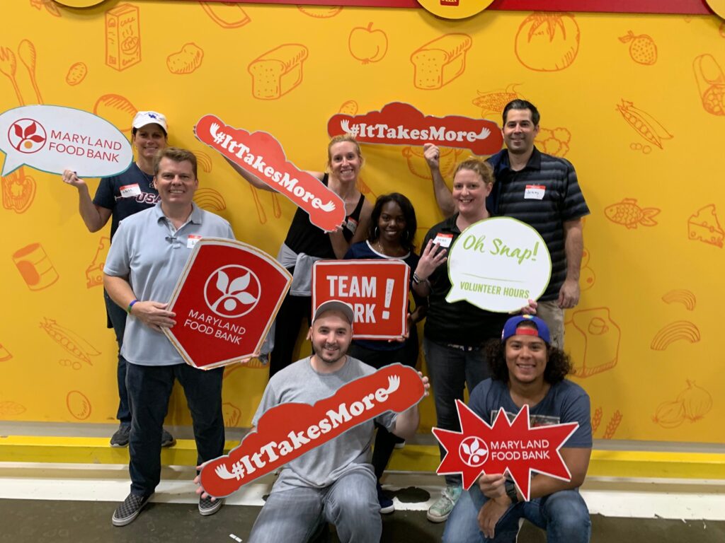 Photo of a team of CallTrackingMetrics employees engaging in corporate volunteering at Maryland Food Bank. 