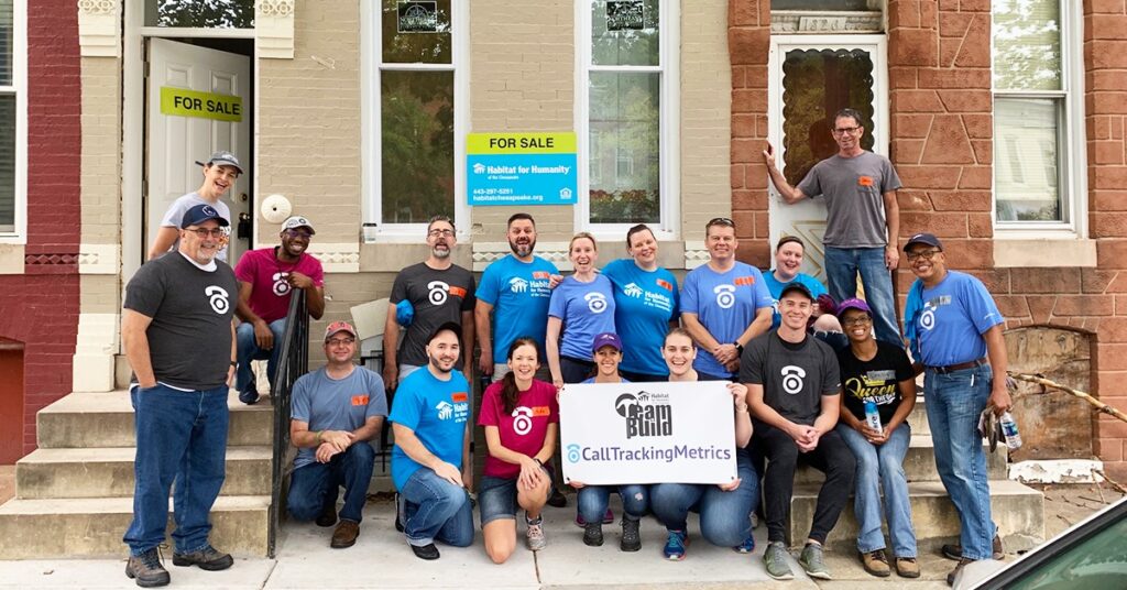 Team photo of CallTrackingMetrics' employees engaging in a corporate volunteer opportunity with Habitat for Humanity. 