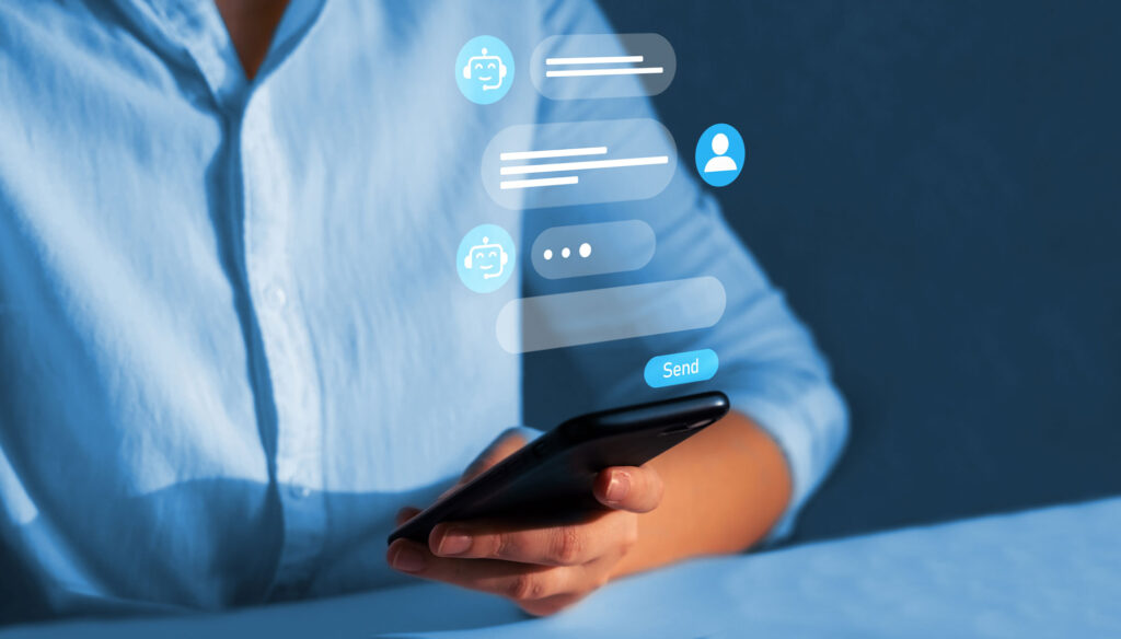 Image of a person in a blue shirt holding a phone with an overlaid image of a conversation with a chatbot or virtual agent. 