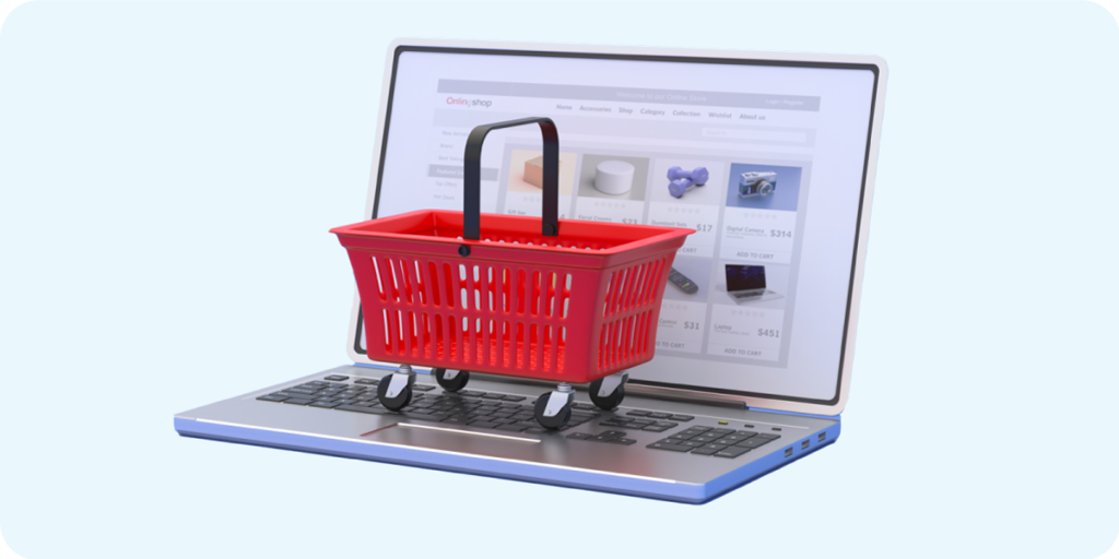 Red handheld shopping basket on top of a laptop indicating a shopper ready to buy. 